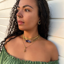 Woman wearing amethyst & citrine crystal necklace