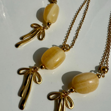 Necklace with gold bows and yellow calcite crystal bead